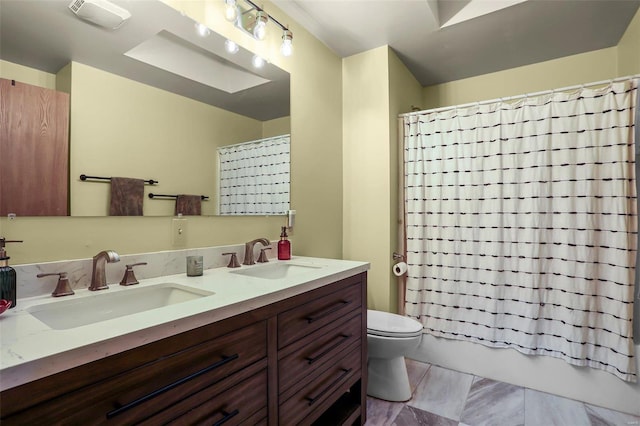 full bathroom featuring toilet, vanity, and shower / bathtub combination with curtain