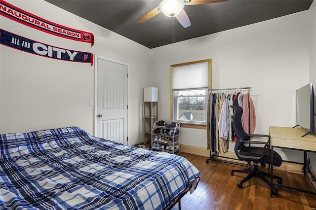 bedroom with dark hardwood / wood-style floors and ceiling fan