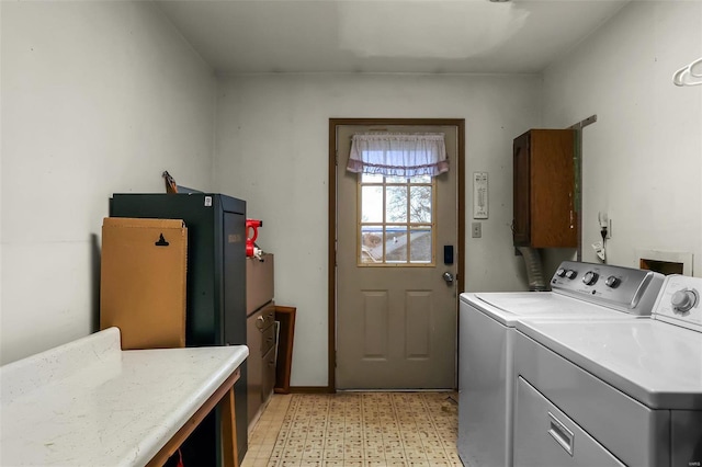 laundry room with cabinets and washer and dryer