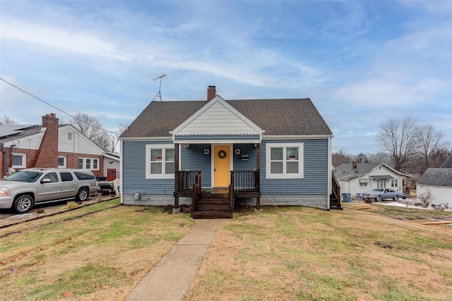 bungalow-style home featuring a front yard