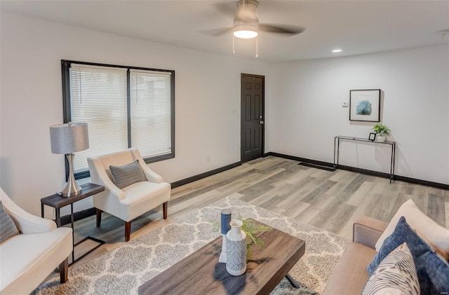 living room featuring ceiling fan and light wood-type flooring