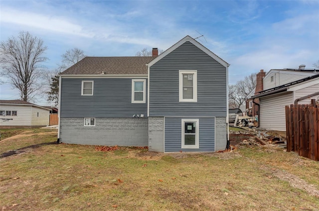 rear view of house featuring a yard