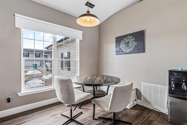 dining area with baseboards, plenty of natural light, visible vents, and wood finished floors