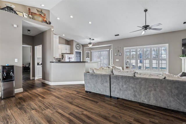 unfurnished living room with high vaulted ceiling, ceiling fan, baseboards, and dark wood-type flooring