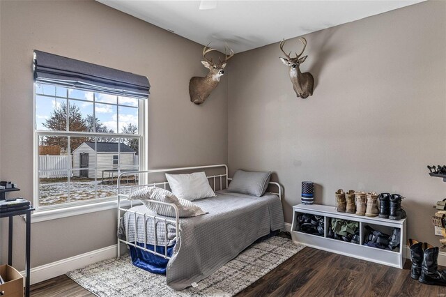 bedroom featuring baseboards and wood finished floors