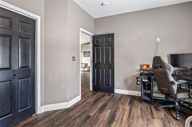office space with dark wood-style floors and baseboards
