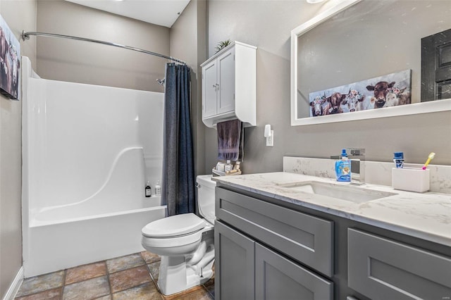 full bathroom with toilet, stone finish floor, vanity, and shower / tub combo with curtain