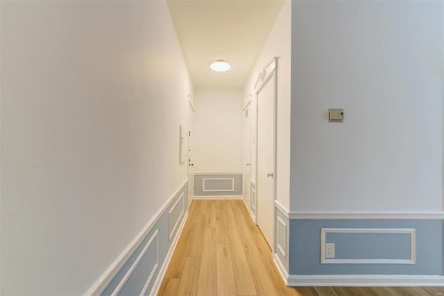 corridor with light hardwood / wood-style flooring