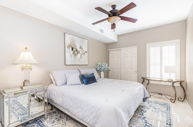 bedroom featuring carpet, ceiling fan, and a closet