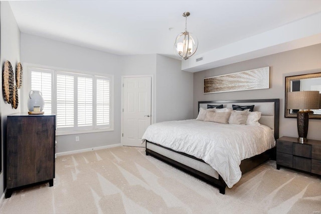 carpeted bedroom featuring an inviting chandelier