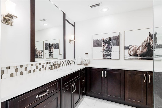 bathroom featuring vanity and decorative backsplash