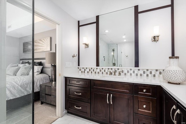 bathroom featuring vanity and backsplash