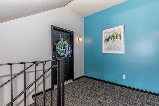 hall featuring carpet floors and vaulted ceiling