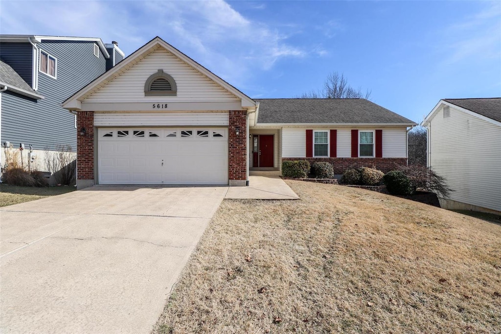 ranch-style home with a garage and a front yard