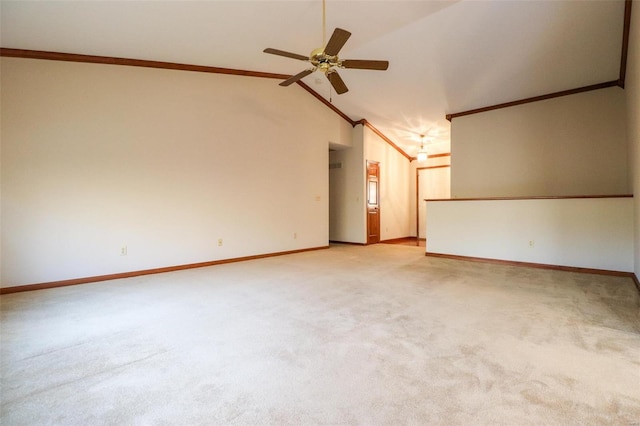 carpeted empty room featuring vaulted ceiling, ornamental molding, and ceiling fan