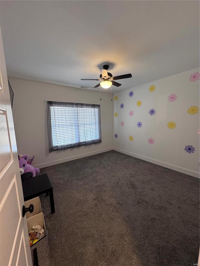 unfurnished bedroom with dark carpet and ceiling fan