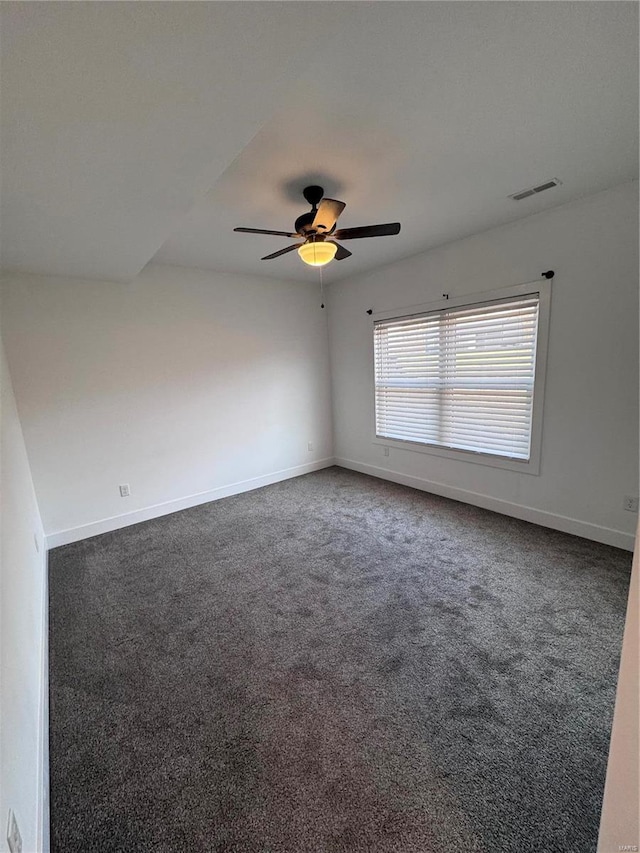 carpeted spare room featuring ceiling fan