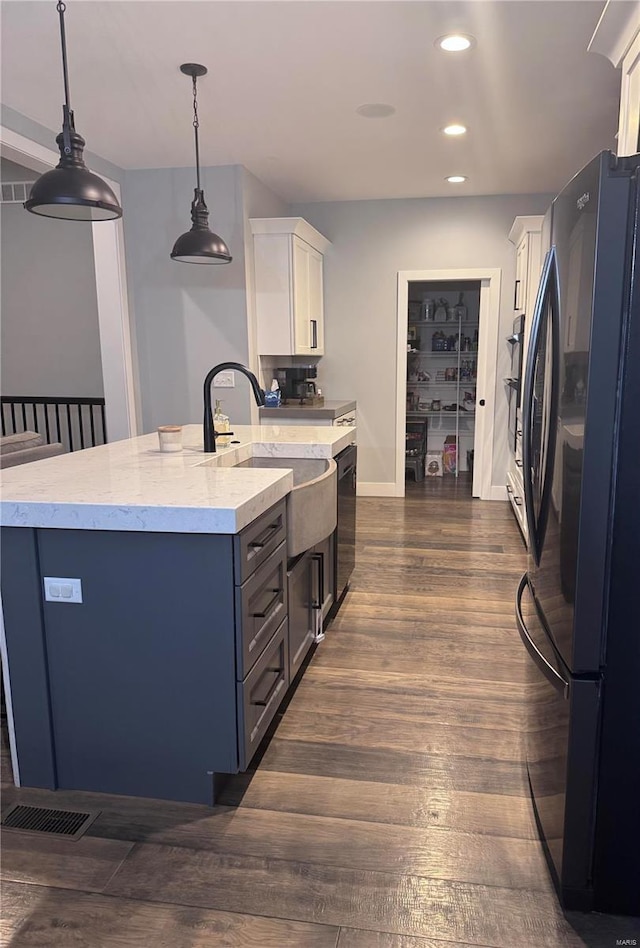 kitchen featuring hanging light fixtures, dark hardwood / wood-style floors, white cabinets, and black appliances