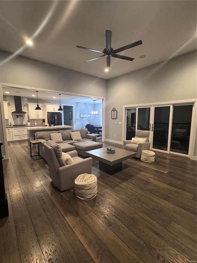 living room featuring dark hardwood / wood-style flooring and ceiling fan