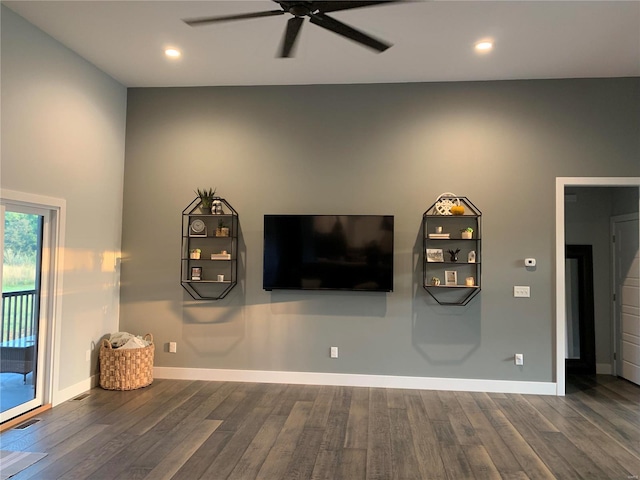 unfurnished living room with ceiling fan and dark hardwood / wood-style flooring