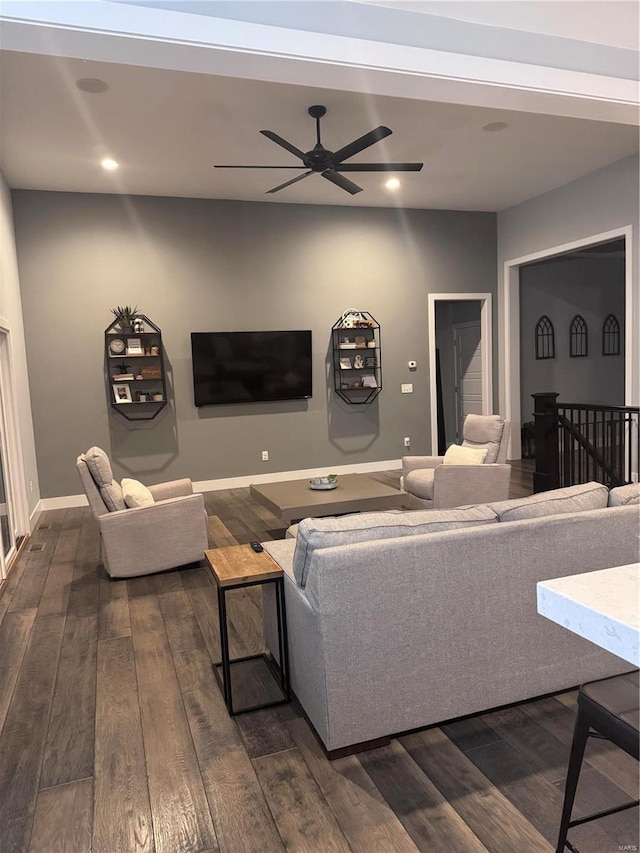 living room with ceiling fan and dark hardwood / wood-style flooring