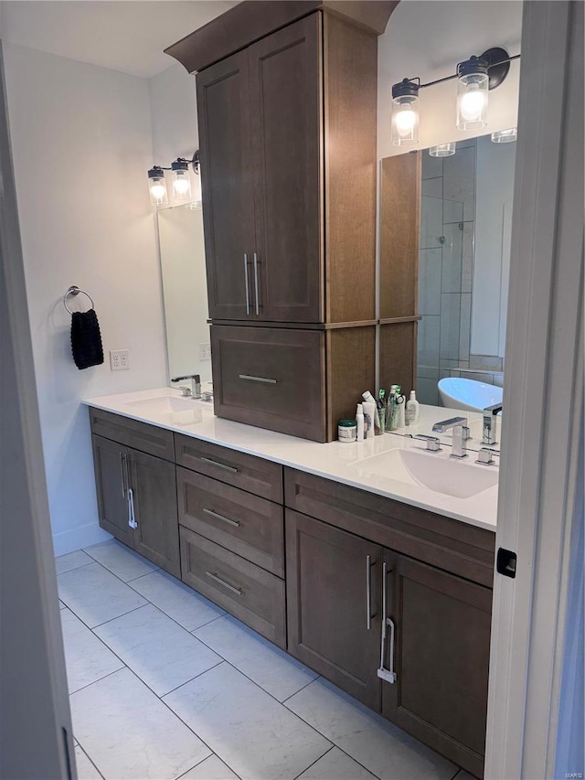 bathroom featuring vanity, tile patterned flooring, and a bathtub