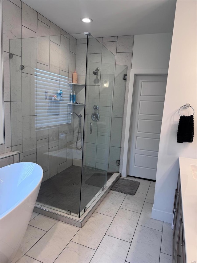 bathroom with vanity and separate shower and tub