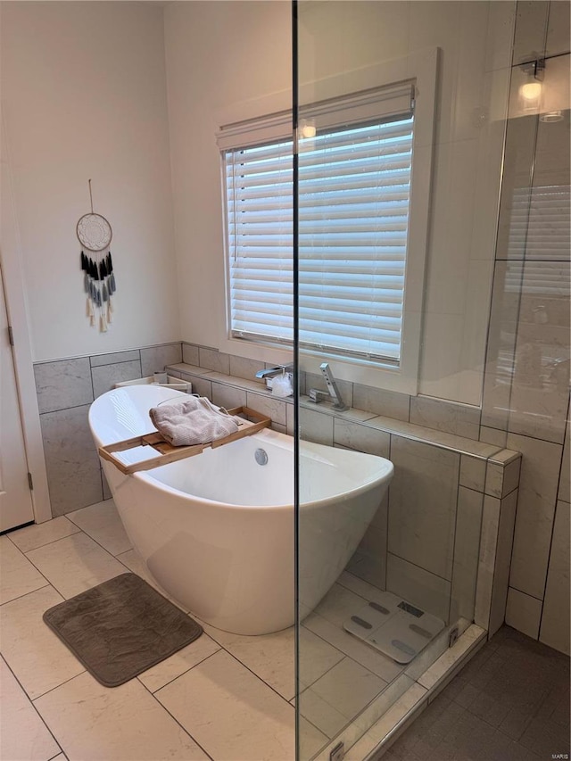 bathroom featuring tile walls, tile patterned floors, and separate shower and tub