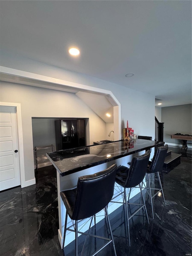 kitchen featuring a breakfast bar and kitchen peninsula