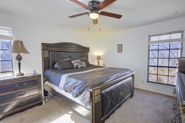 carpeted bedroom featuring ceiling fan and baseboards