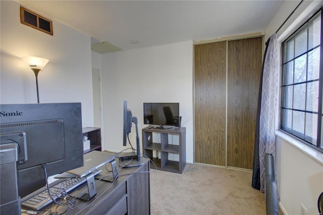 home office featuring carpet floors, visible vents, and baseboards