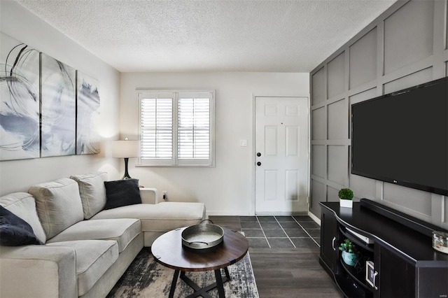 living room with dark hardwood / wood-style flooring and a textured ceiling