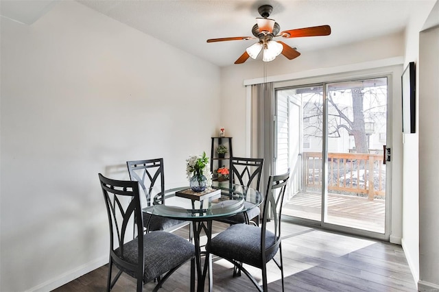 dining space featuring hardwood / wood-style floors and ceiling fan