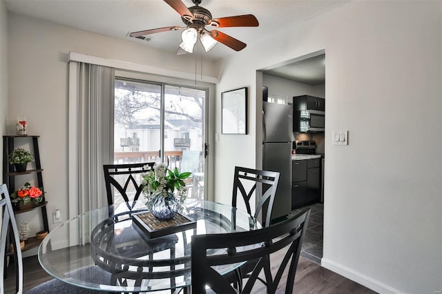 dining space featuring dark wood-type flooring and ceiling fan