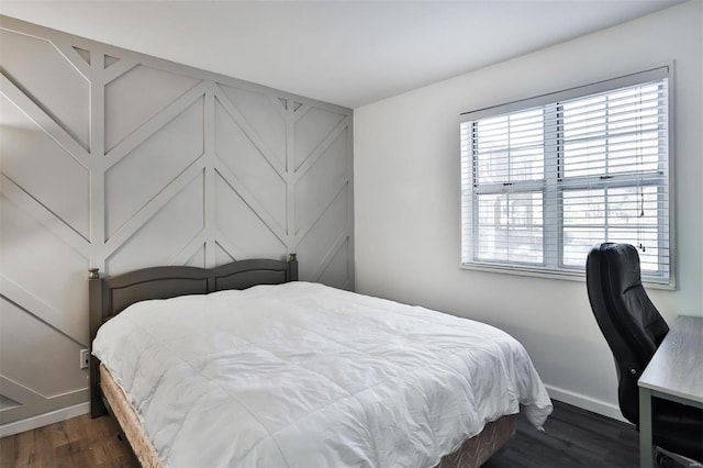 bedroom with dark wood-type flooring