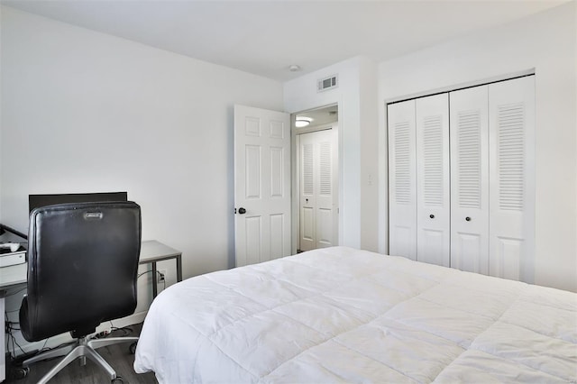 bedroom with wood-type flooring and a closet