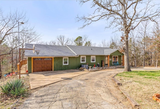 single story home with central AC and a garage