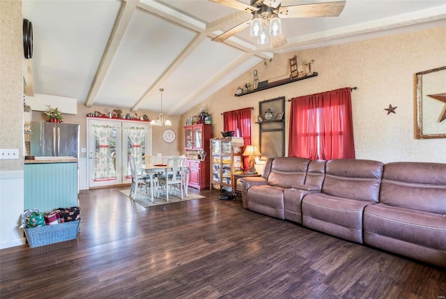 living room with vaulted ceiling with beams, ceiling fan with notable chandelier, and dark wood-type flooring