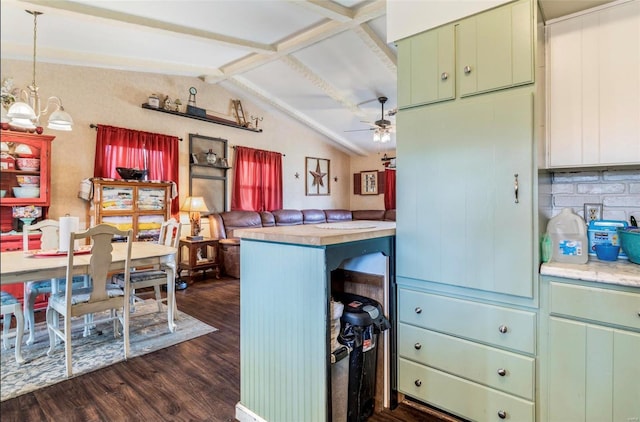 kitchen featuring hanging light fixtures, lofted ceiling with beams, dark hardwood / wood-style flooring, ceiling fan with notable chandelier, and kitchen peninsula