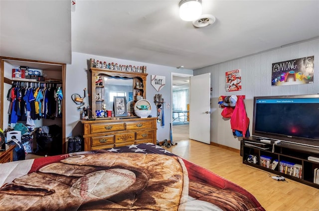 bedroom with hardwood / wood-style floors and a closet