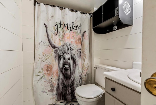 bathroom featuring walk in shower, vanity, and toilet