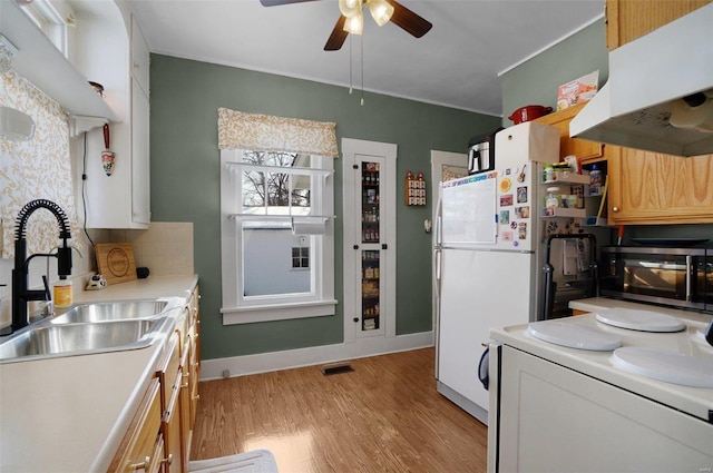 kitchen with white cabinetry, light hardwood / wood-style floors, sink, and stove