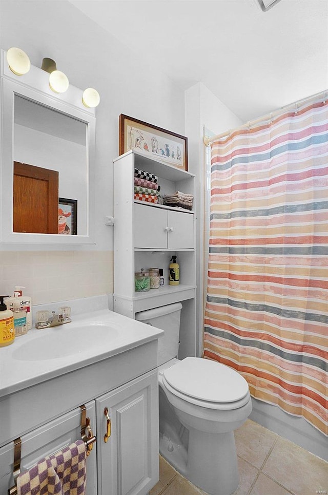 full bathroom with tile patterned flooring, vanity, toilet, and shower / bath combo with shower curtain