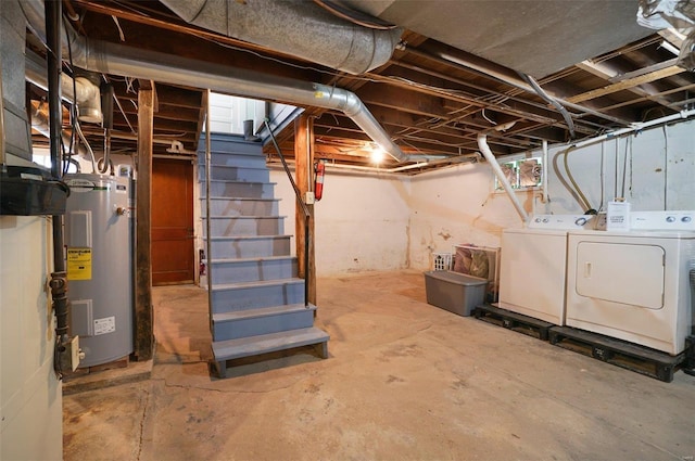 basement featuring water heater and separate washer and dryer