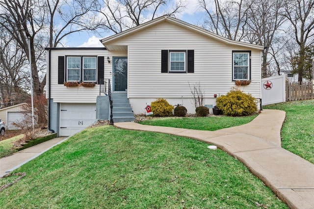 view of front of house with a garage and a front lawn