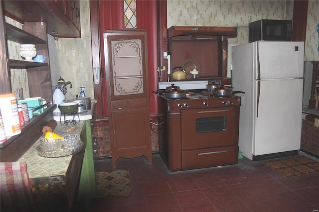 kitchen with white refrigerator, sink, and stove