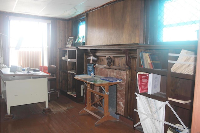 office area with hardwood / wood-style flooring and wood walls