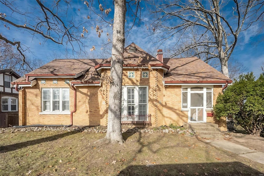 english style home with a front yard