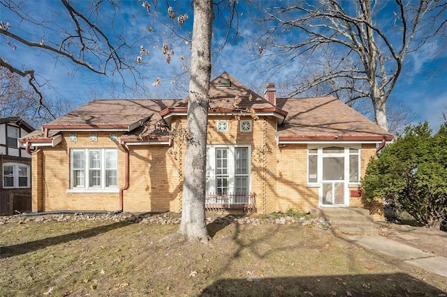 english style home with a front yard