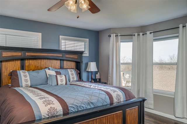 bedroom with dark hardwood / wood-style flooring and ceiling fan